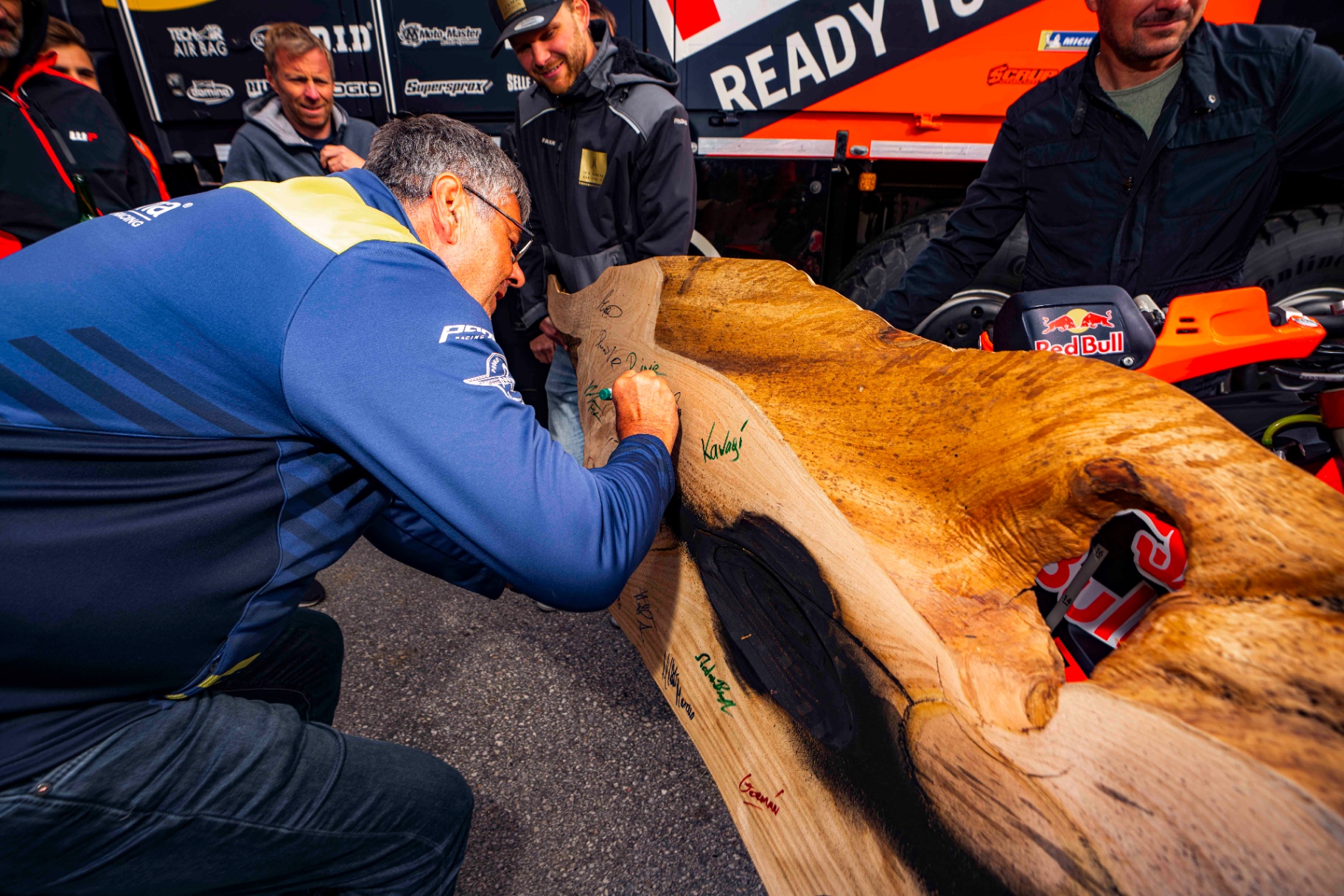 Riders signing the piece in the paddock