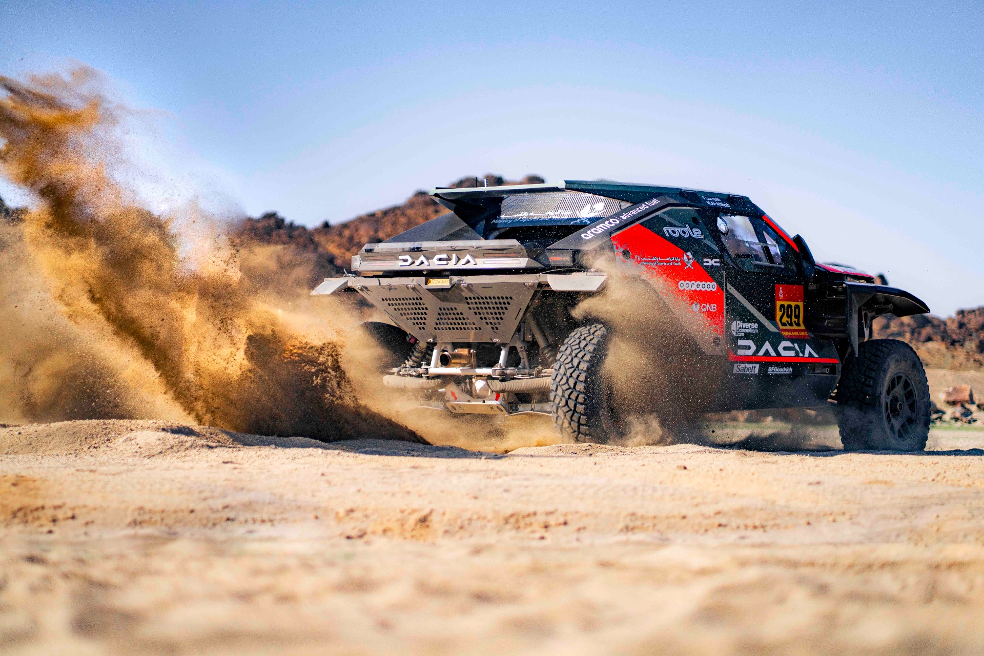 Dacia trailing dust in the dunes